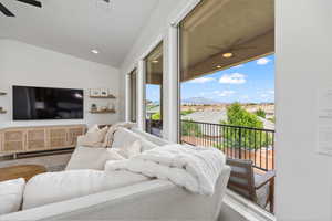 Living room with a ceiling fan, vaulted ceiling, recessed lighting, and a mountain view