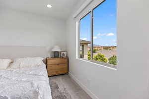 Bedroom with light carpet, a mountain view, and recessed lighting