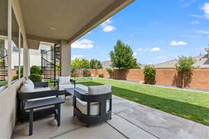 Fenced backyard featuring a patio, outdoor lounge area, and stairs