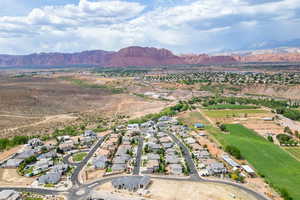 Aerial view of property's location with nearby suburban area and mountains