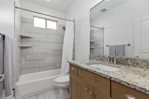Bathroom with vanity and shower / bath combination with curtain