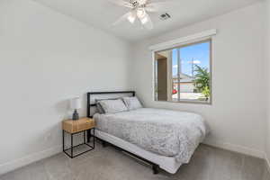 Bedroom with light carpet and ceiling fan