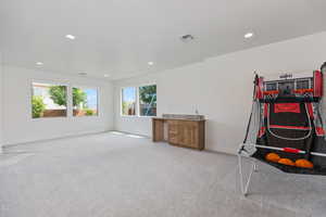 Game room with recessed lighting and light carpet