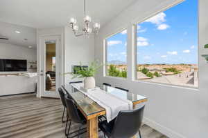 Dining space with light wood-style floors, a chandelier, plenty of natural light, a mountain view, and recessed lighting