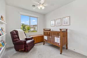 Bedroom featuring light carpet and a ceiling fan
