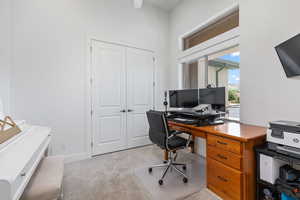 Office with light colored carpet and baseboards