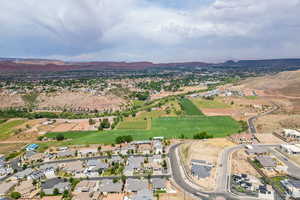 Aerial overview of property's location featuring nearby suburban area and mountains