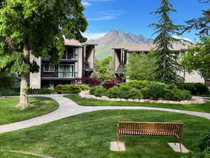 front of home featuring a large lawn and a mountain view