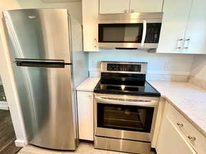 Kitchen with stainless steel appliances, and soft-closing cabinets