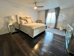 extra large master Bedroom featuring wood finished vinyl floors, baseboards, and ceiling fan