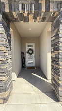 Doorway to property with stone siding