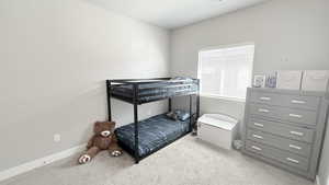 Bedroom featuring carpet floors and baseboards