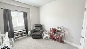 Carpeted bedroom with baseboards