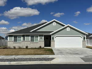 Ranch-style home with brick siding, a garage, and concrete driveway