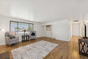 Living area with light wood-type flooring and baseboards
