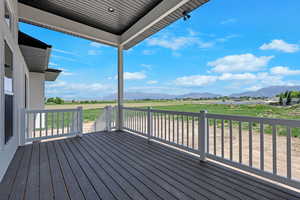 Wooden terrace featuring a mountain view and a rural view