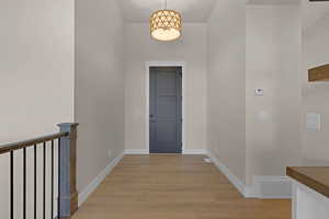 Hall with light wood finished floors and baseboards