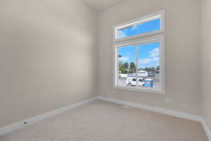 Unfurnished room featuring carpet flooring and baseboards