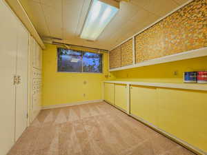 Spare room featuring light colored carpet and baseboards