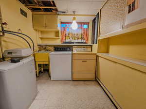 Laundry and utility room with a washer and dryer, light countertops, light floors, and a sink