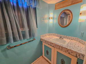 Bathroom featuring vanity and baseboards
