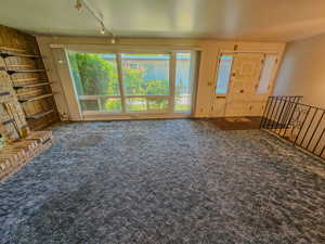 Living room featuring carpet flooring and rail lighting