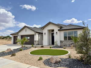Ranch-style home featuring stone siding, a garage, stucco siding, and a tile roof