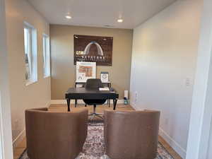 Home office featuring wood finished floors, baseboards, and recessed lighting
