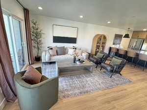 Living area featuring light wood-style floors and recessed lighting