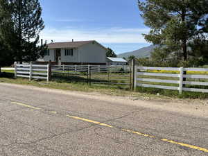 White vinyl fence and gate to access side property.