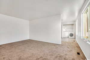 Unfurnished room featuring light colored carpet