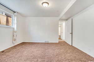 Unfurnished room with carpet floors and baseboards