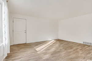 Additional living space featuring light wood-style flooring