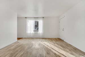 Unfurnished room featuring light wood-style floors and baseboards