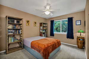 Bedroom with carpet, baseboards, and a ceiling fan