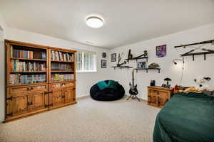 Bedroom featuring carpet floors and baseboards