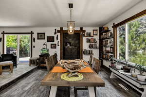 Dining space with wood finished floors and a textured ceiling