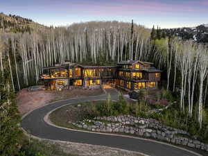 Rear view of property featuring a view of trees