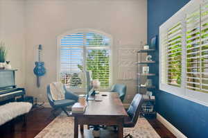 Office space with wood finished floors and baseboards