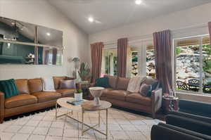 Living area with lofted ceiling, plenty of natural light, and recessed lighting
