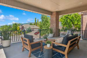 View of patio with a balcony and a mountain view
