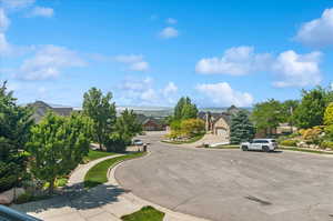 View of asphalt street with sidewalks, curbs, and a residential view