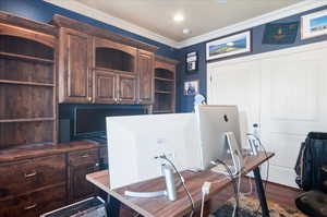 Office space featuring ornamental molding and dark wood-style flooring