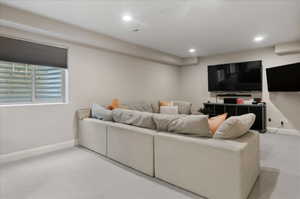Living room with carpet flooring, recessed lighting, and baseboards