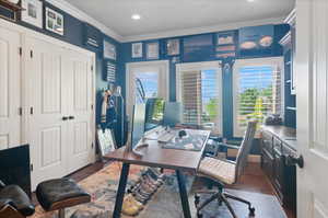 Home office with ornamental molding, dark wood-type flooring, and recessed lighting