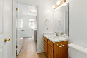 Bathroom featuring vanity, wood finished floors, and toilet