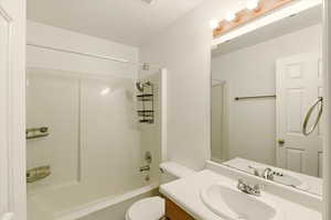 Full bath with toilet, vanity, and shower / bath combination