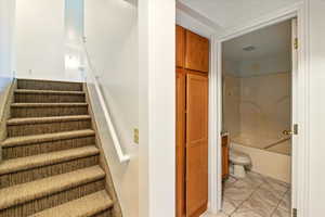 Staircase featuring marble finish floors