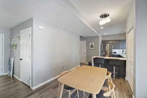 Dining room featuring wood finished floors, baseboards, and recessed lighting