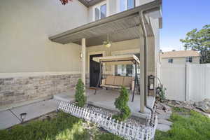 Property entrance with stucco siding and a patio